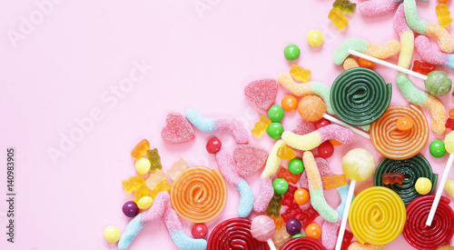 Colorful candy and fruit jelly jujube on a pink background photo