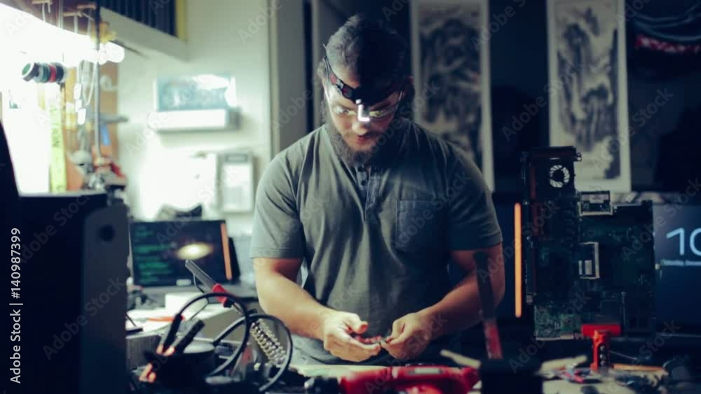 Man Soldering Wires for Device at Engineering Workshop Table Man Soldering Wires for Device at Engineering Workshop Table