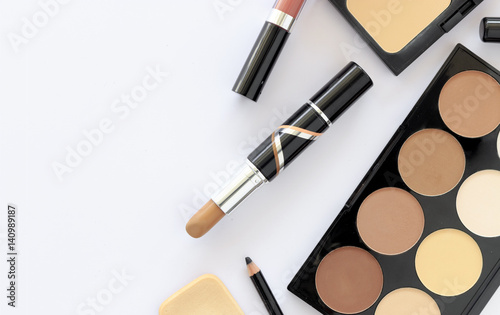 makeup cosmetics on white table background with text space, over light, top view