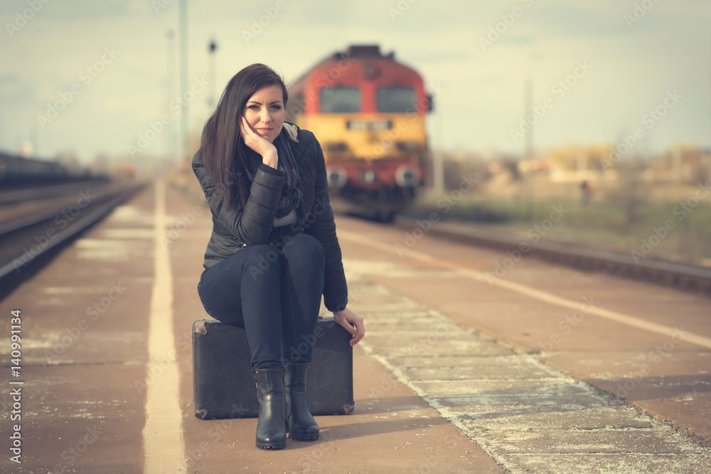 Fototapeta premium Cute woman at the train station