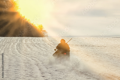 hunters by snowmobile in snowy field
