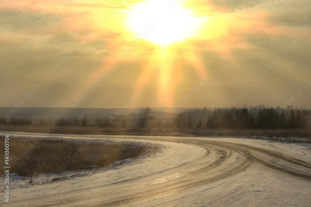 sun in the haze of a winter road