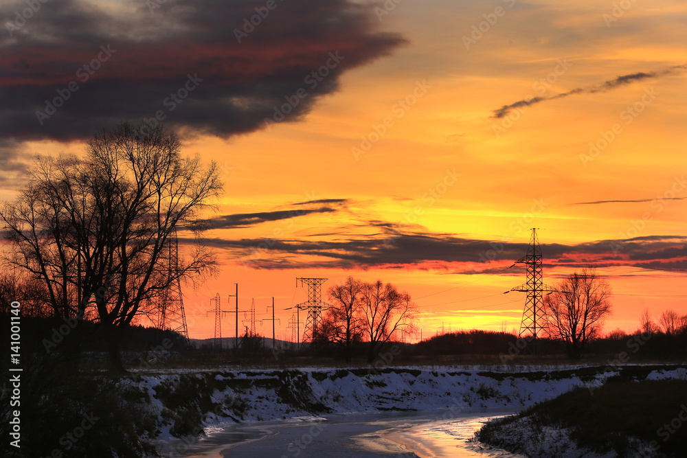 transmission line on a background of bright red sunset transmission line on a background of bright red sunset