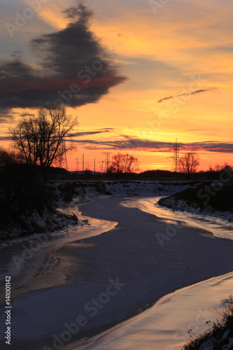 transmission line on a background of bright red sunset