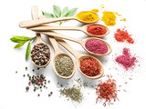 Assortment of colorful spices in the wooden spoons on the white background.