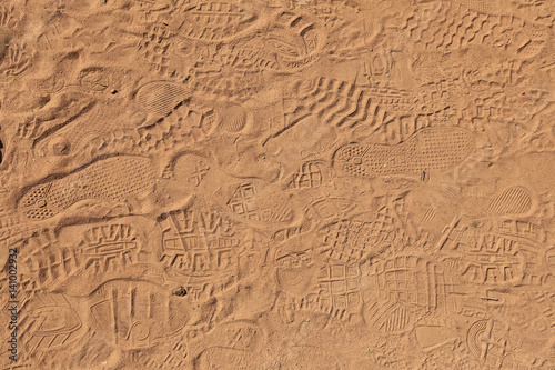 Fototapeta Naklejka Na Ścianę i Meble -  background texture of sand with traces of shoes