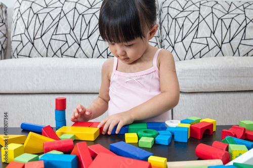 Asian Chinese little girl playing building blocks at home photo