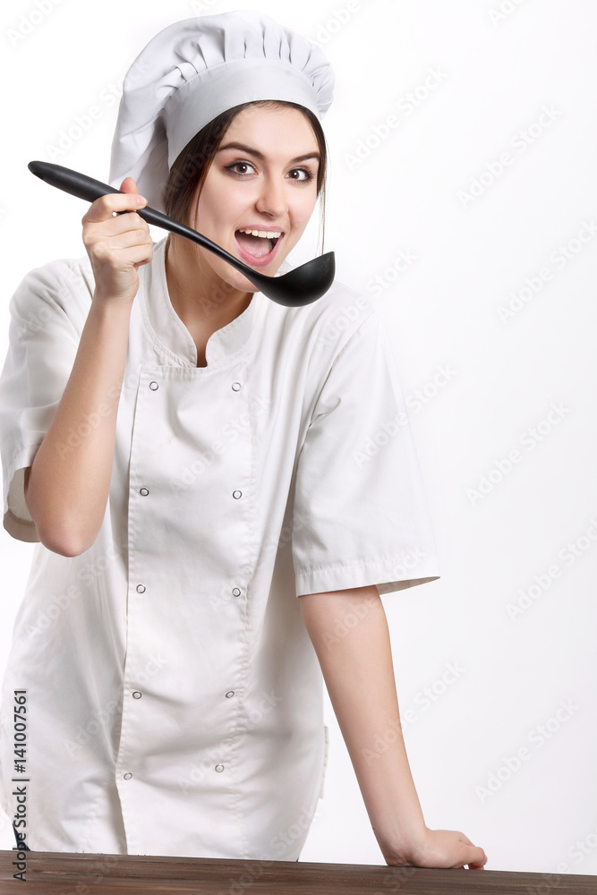 Young woman chef with scoop isolated on white Young woman chef with scoop isolated on white