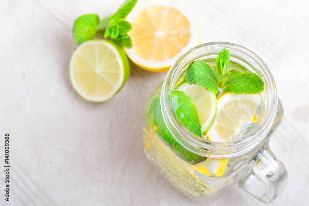 Summer drink lemonade mojito with lime, lemon and mint in mason jar Summer drink lemonade mojito with lime, lemon and mint in mason jar