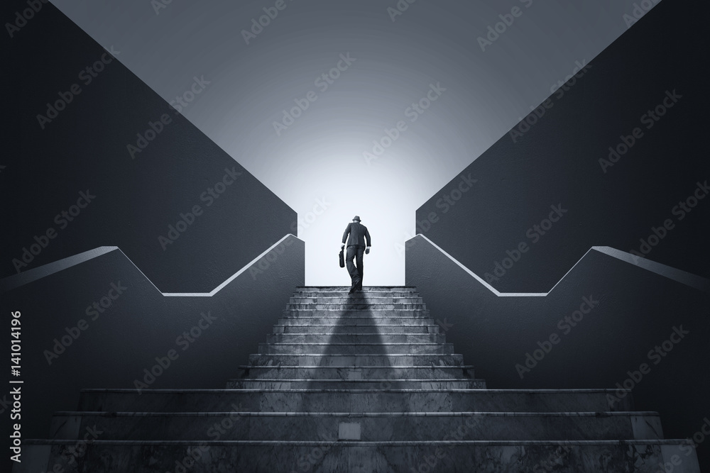 Businessman climbing stairs. Ambitions concept