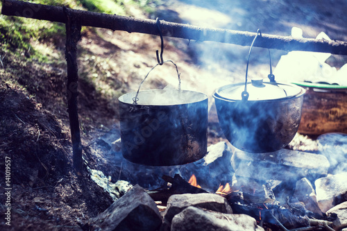 Cooking in a hiking trip, eating in the mountains, tourism. Cooking at the stake.