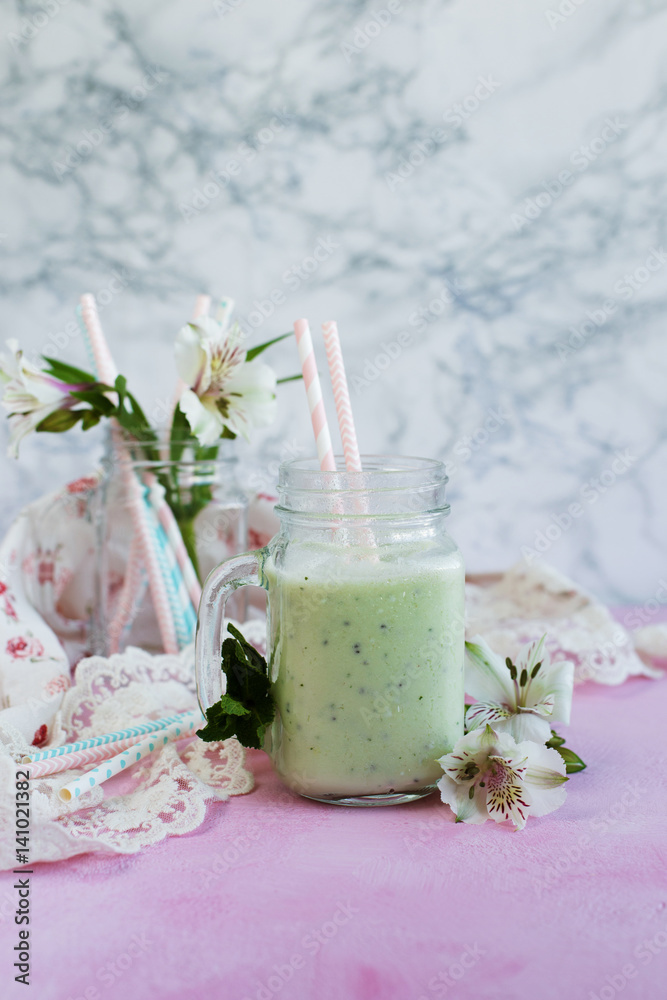 Breakfast smoothie of kiwi and milk on light background Breakfast smoothie of kiwi and milk on light background