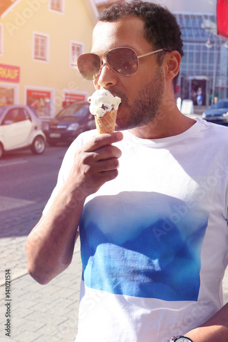 Interracial man eating ice cream