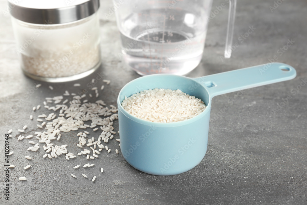Kitchen ware with rice and water on table Kitchen ware with rice and water on table