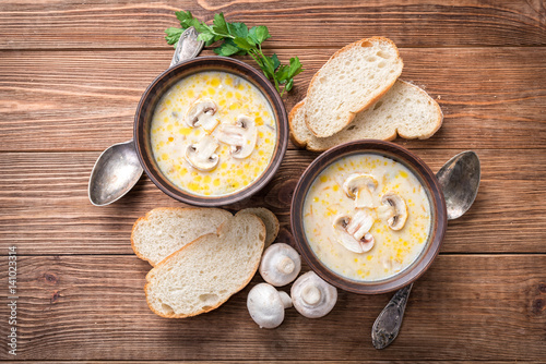 Mushroom  soup  on a  rustic wooden background . 