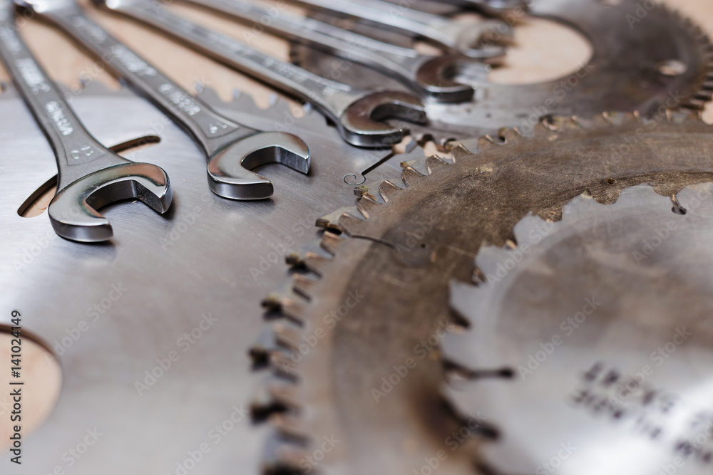 Circular saws and set of wrenches in carpenter workshop Circular saws and set of wrenches in carpenter workshop