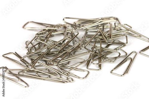 Heap of metal clips isolated on a white background photo