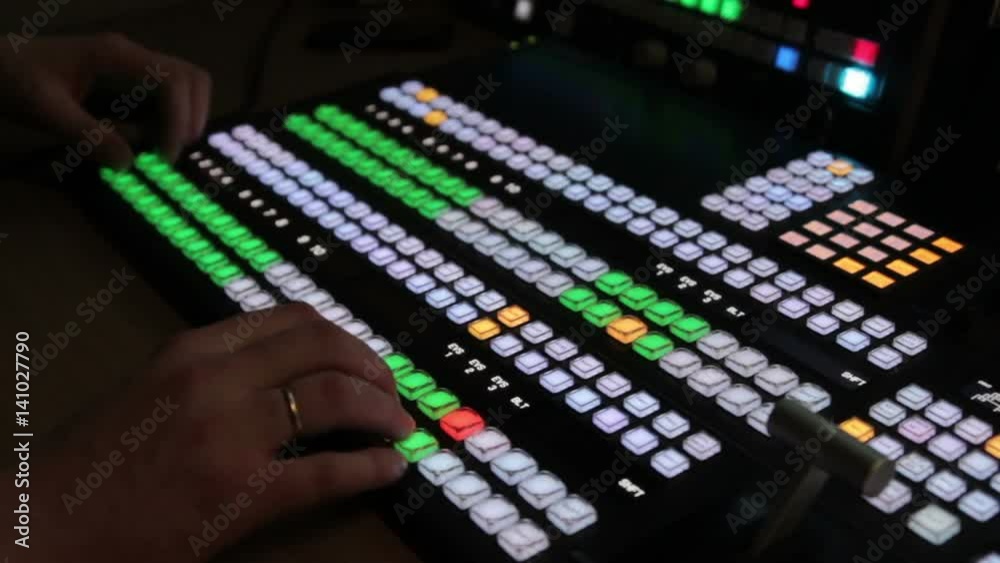 Director works with the video mixer during live broadcast on TV. Director works with the video mixer during live broadcast on TV.