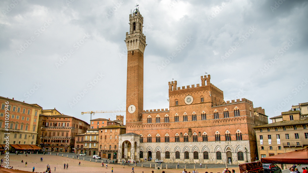 Siena, Italy - September 5, 2014: The Campo Square with Mangia Tower the landmark of Siena, Italy.