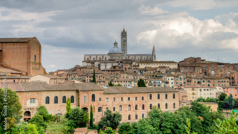 Siena, Italy - September 5, 2014: The wonderful medieval city of Siena with Siena Cathedral in Tuscany region on a cloudy day