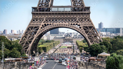 Fototapeta Naklejka Na Ścianę i Meble -  Paris, France - September 10, 2016: The legs of Eiffel Tower with tourist crowd waiting in lines