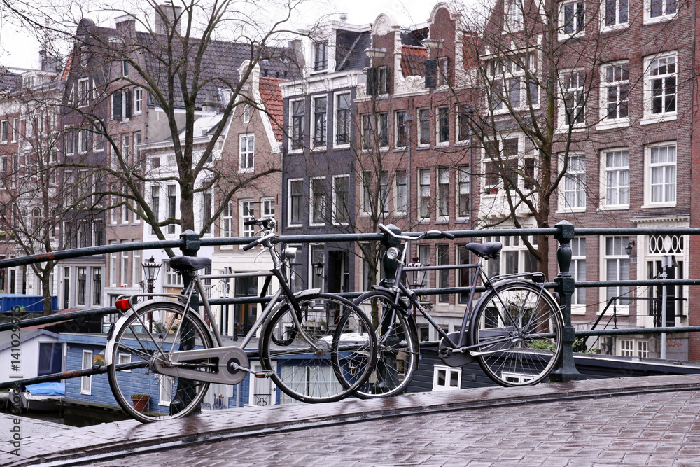 two bikes on bridge in amsterdam