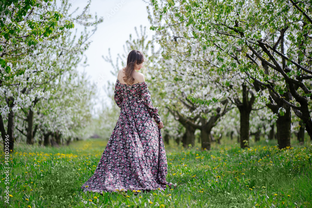 beautiful woman in dress in the gardens