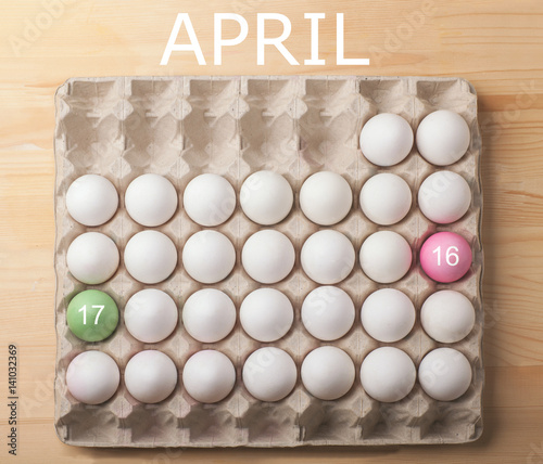 Easter calendar of April 2017 - white eggs and easter painted eggs in pack symbolic easter and easter monday days of month