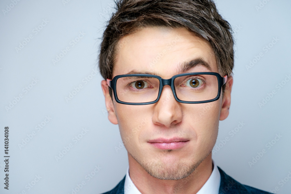 Young businessman in glasses. Surprised face.