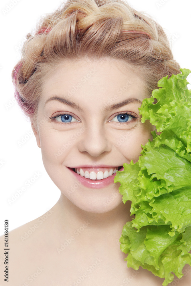 Young beautiful happy smiling young blond girl with green salad leaves Young beautiful happy smiling young blond girl with green salad leaves