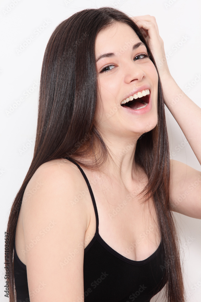 Young beautiful healthy laughing teen girl with long hair