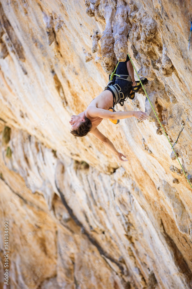 Fototapeta premium Rock climber resting after exhausting attempt
