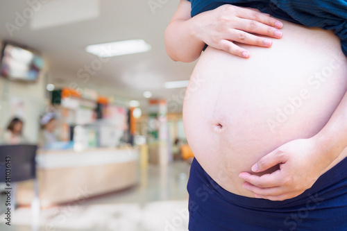 Pregnant woman with hospital blur background