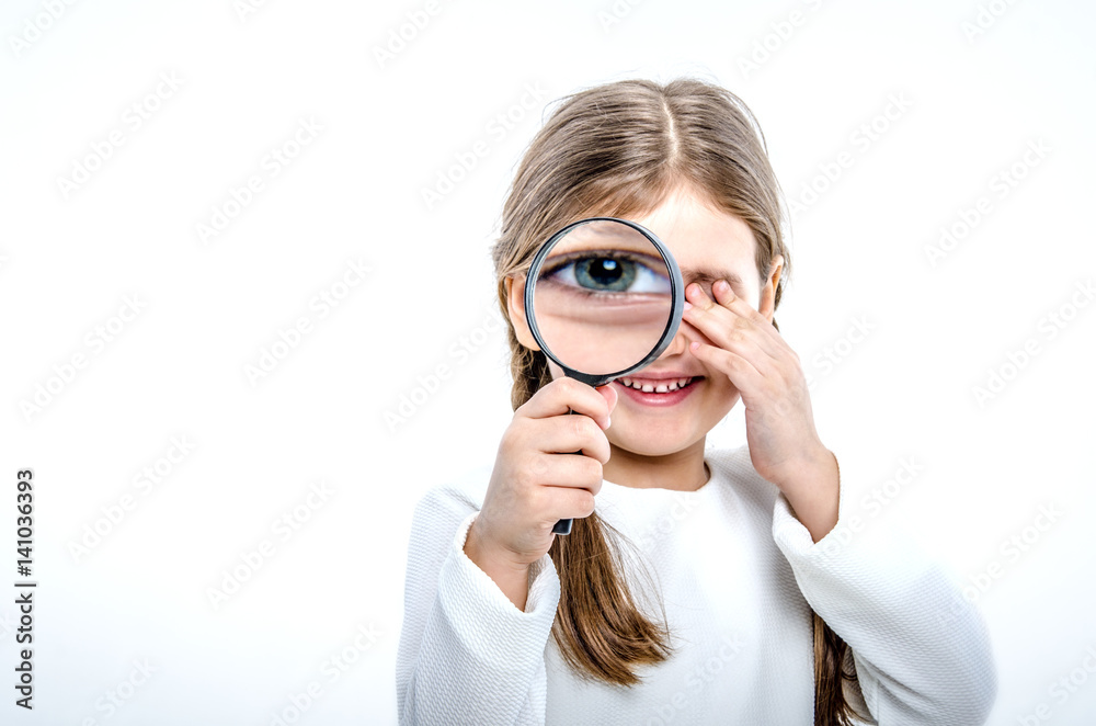 Young woman with magnifying glass in front of her eye