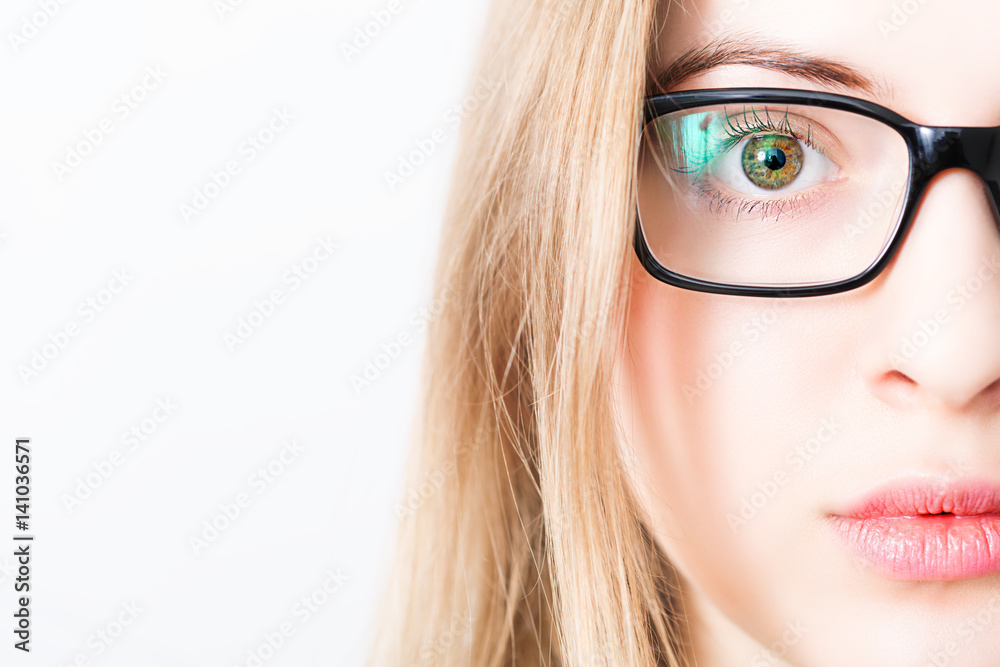 closeup of and eye of blonde woman with black glasses closeup of and eye of blonde woman with black glasses