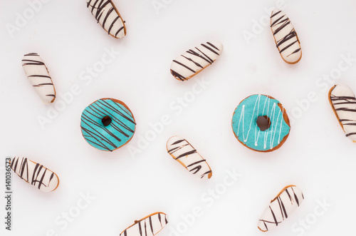Donuts and cookies on white background. Flat lay.