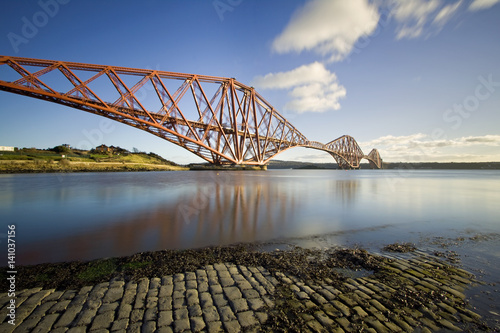 The Forth Rail Bridge is a cantilever railway bridge opened in 1890 that crosses the Firth of Forth between Edinburgh and Fife in Scotland. It is the second largest bridge of its kind in the world.