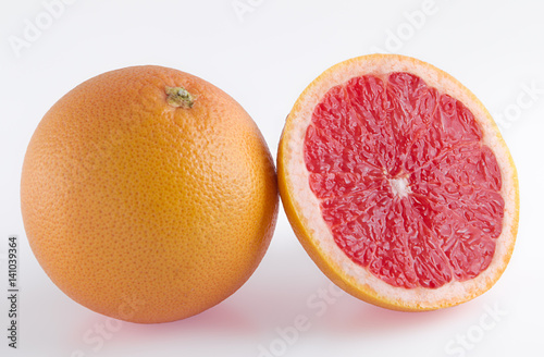Pieces of pink grapefruit over white background