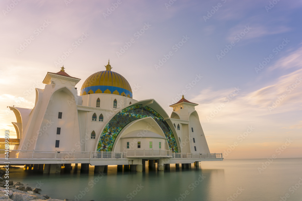 A mosque in Malacca, Malaysia that built near seascape, sunrise with colorful sky 