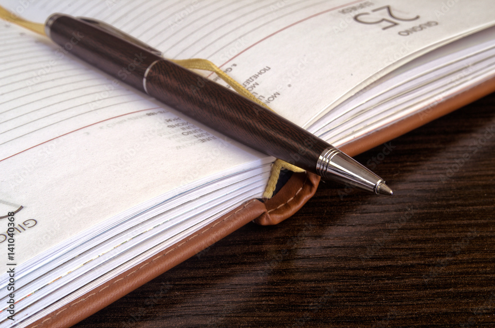 Close up of a pen and notebook. Close up of a pen and notebook.