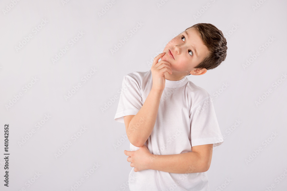 School boy looking up thinking looking for clues or idea isolated on a white School boy looking up thinking looking for clues or idea isolated on a white