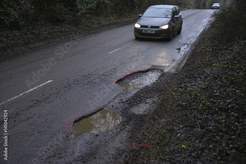 Photos Car approaching a pothole