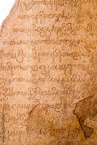 Ancient carved scripture in sinhalese language on a rock at Mamallapuram, Tamil Nadu, India photo