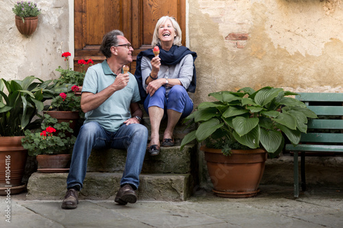 Senior couple eating gelato on vacation