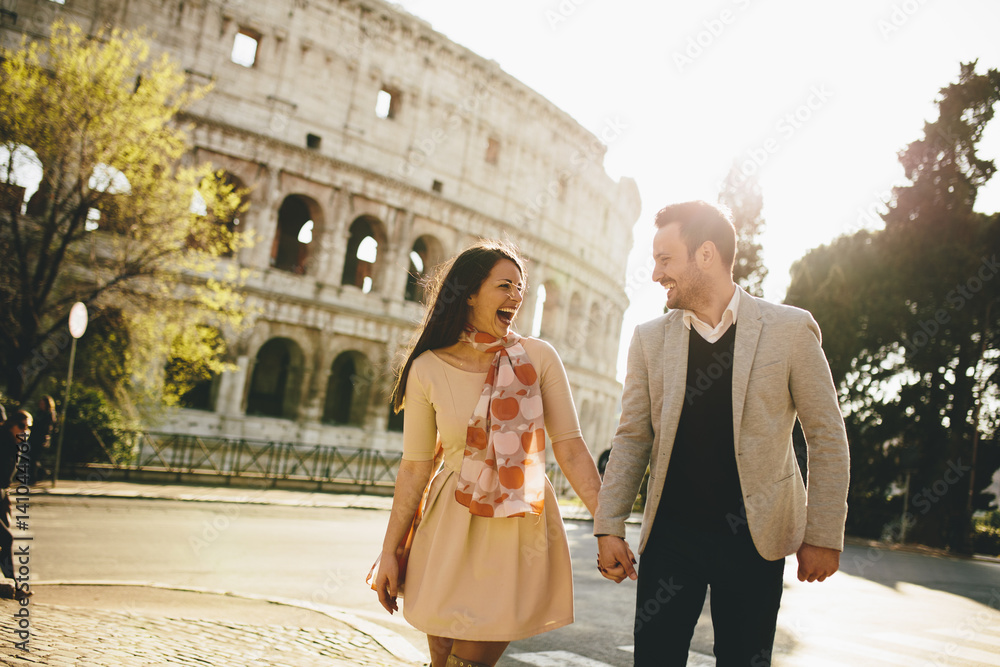 Obraz premium Kochająca para przed Koloseum w Rzymie, Włochy