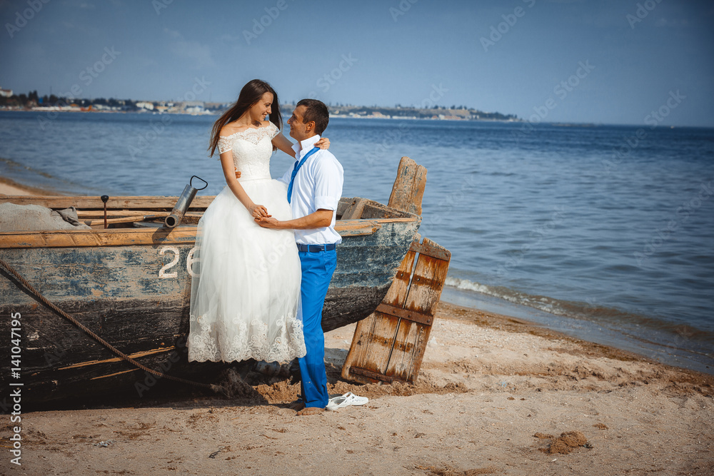 Wedding couple in a boat on the beach