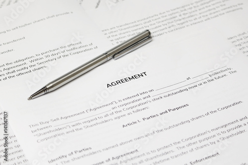 Contract papers with a pen on the table. The documents is ready to be filled out.