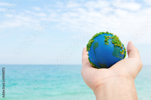 Earth in hand, hand holding world icon with nature , environment friendly concept