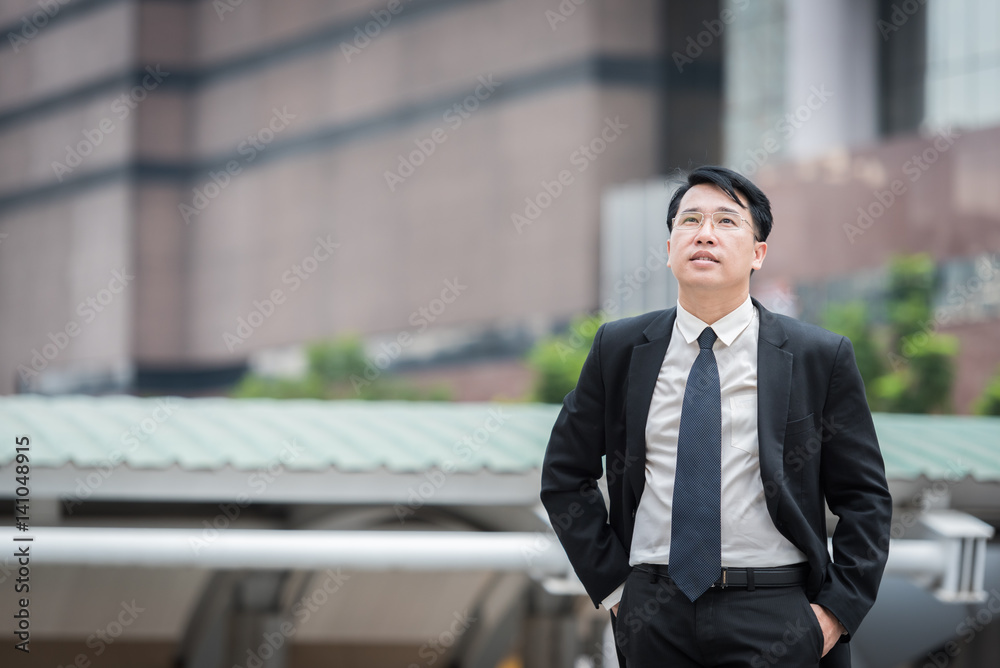 businessman standing in area office building businessman standing in area office building