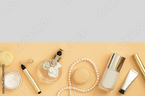 Beauty products and accessories top view on multicolored background. Copy space
